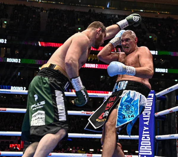 Tyson Fury has fun with a fan before doorstepping a neighbor