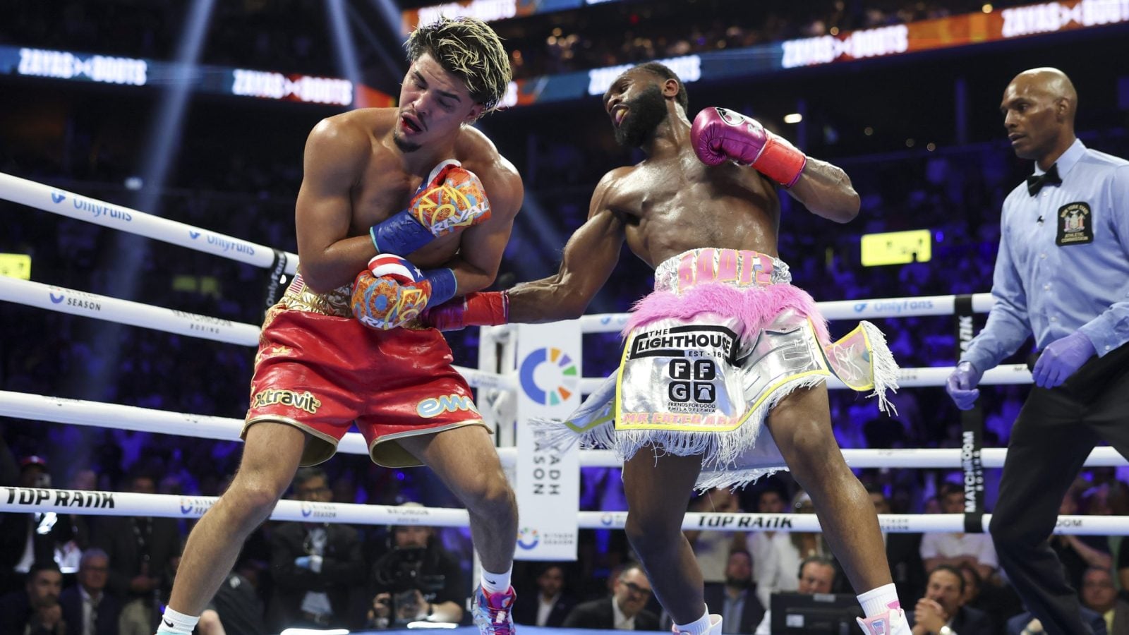 Jaron Ennis lands a right to Xander Zayas's body during their WBO and WBA World Junior Middleweight contest at the Barclays Center in Brooklyn