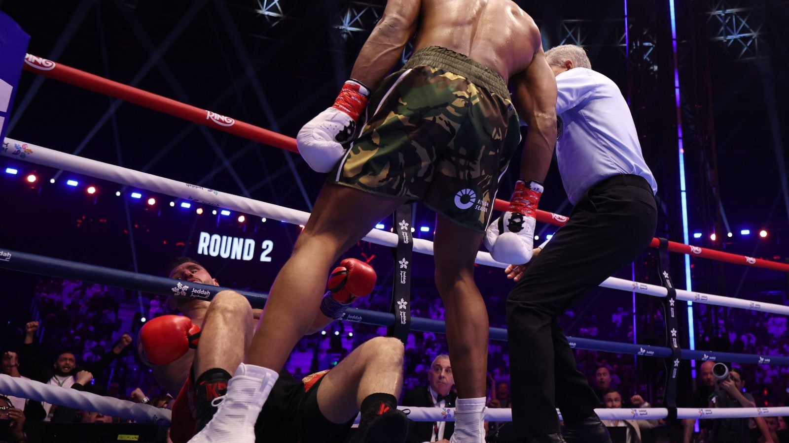 Anthony Joshua knocks Kristian Prenga down between the ropes in the round 2 of their heavyweight contest