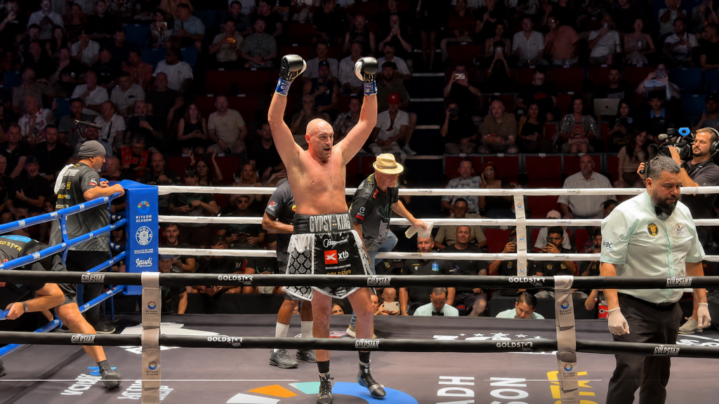 Tyson Fury celebrates after Maruisz Wach retires on his stall
