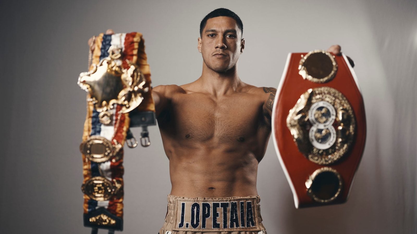 Jai Opetaia hold up his Ring & IBF Cruiserweight titles during a photoshoot