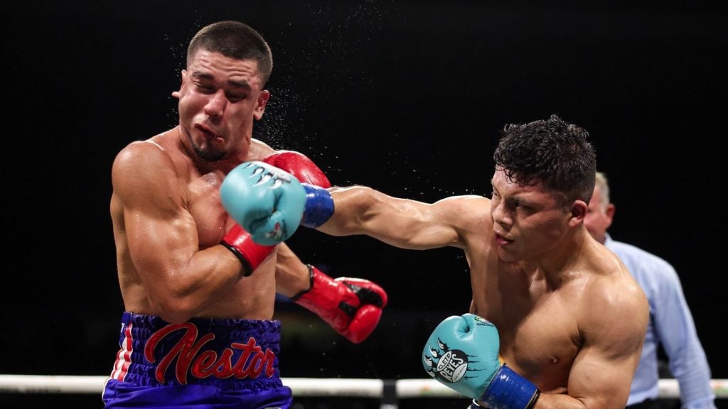 Isaac "Pitbull" Cruz connects with a right hand on Nestor Bravo during their super-lightweight contest.