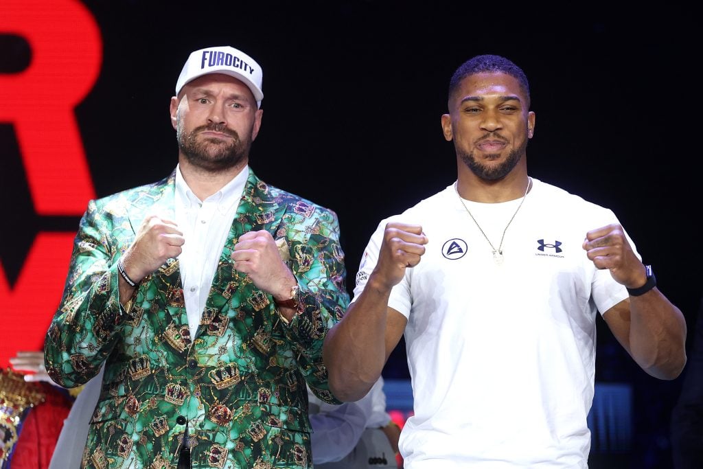 Tyson Fury and Anthony Joshua pose after their face-off at the launch press conference for their December 11 fight.