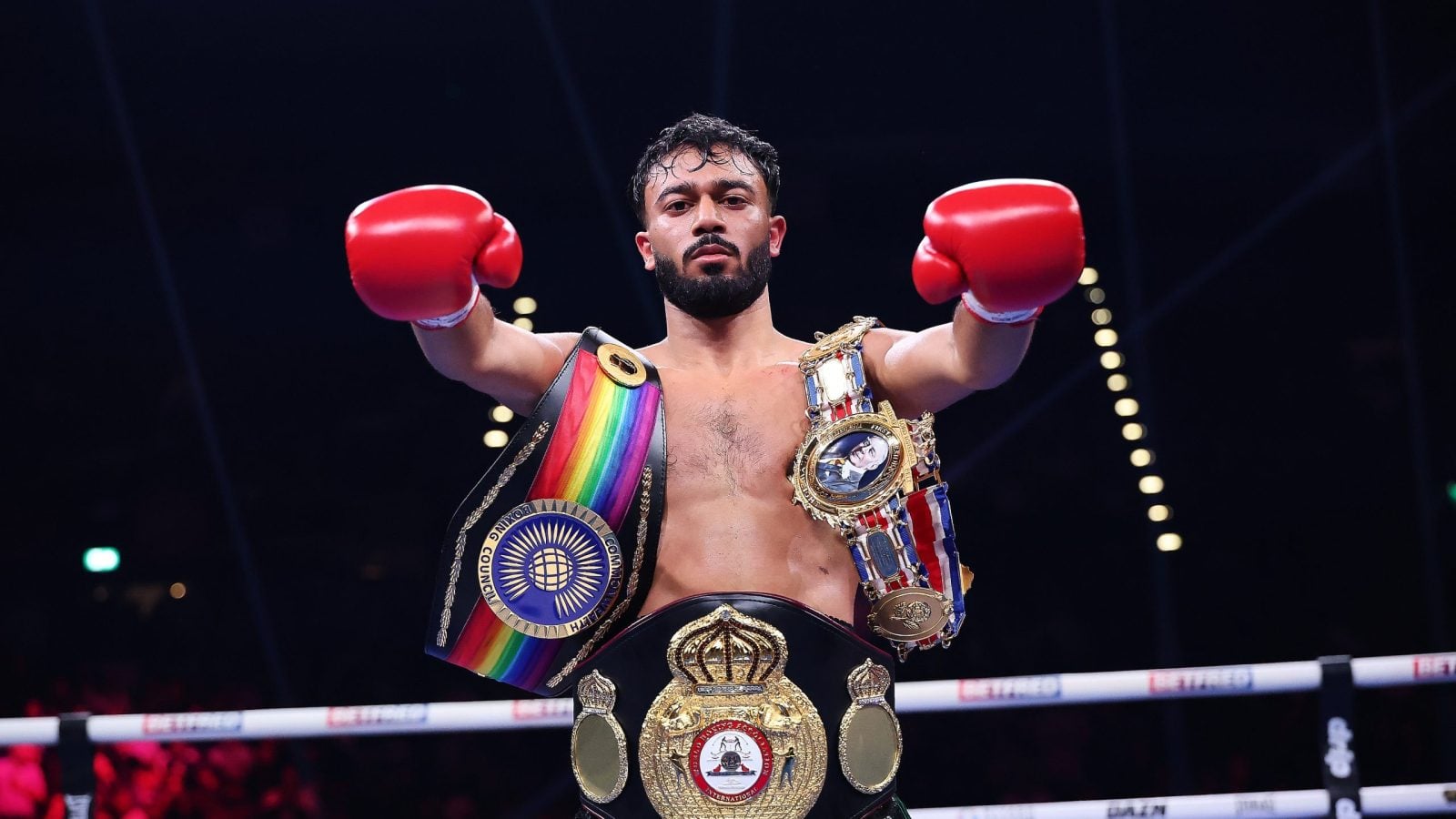Hamza Uddin celebrates with the British and Commonwealth flyweight titles after defeating Sean Bruce in Birmingham.