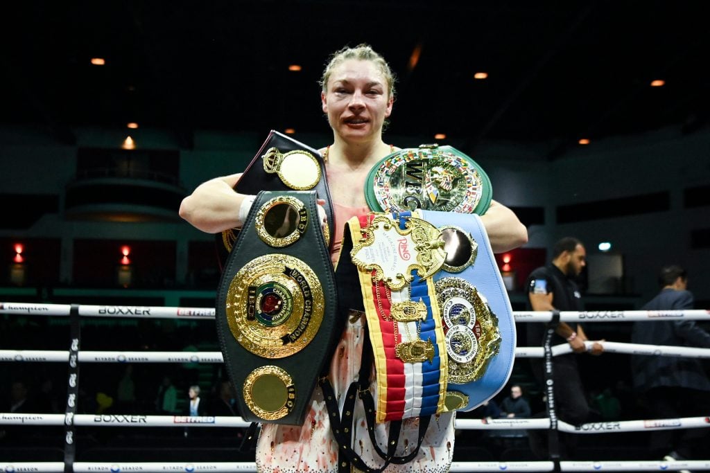 Lauren Price poses with her world championship belts following her victory over Stephanie Piñeiro.